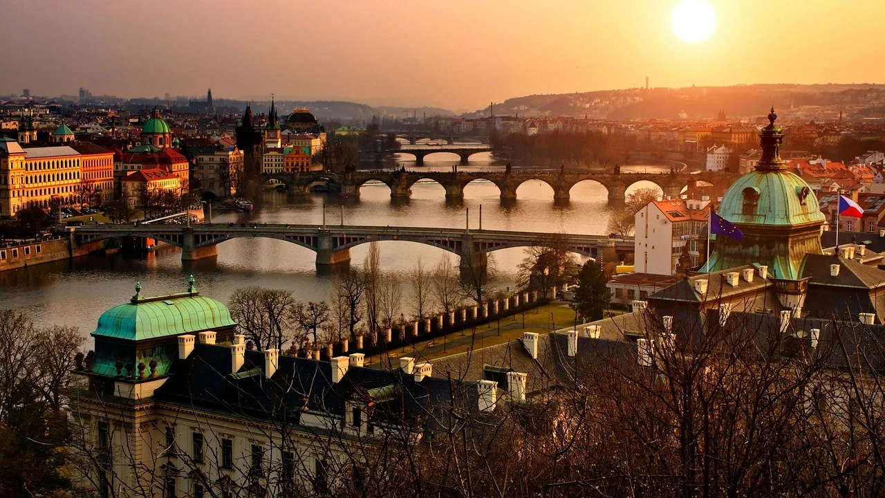 Vue aérienne de Prague mettant en avant ses ponts emblématiques traversant la Vltava, avec une perspective panoramique sur l’architecture historique de la ville