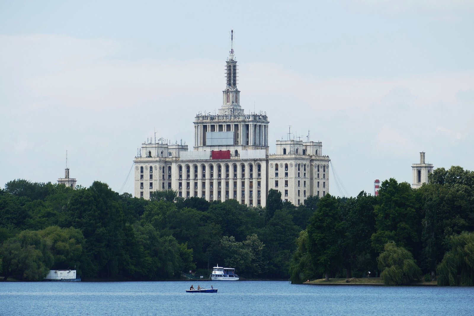 Casa Scînteii, Bucarest Vue sur la célèbre Casa Scînteii à Bucarest, imposant bâtiment de style stalinien entouré de verdure et symbole de l’architecture communiste roumaine